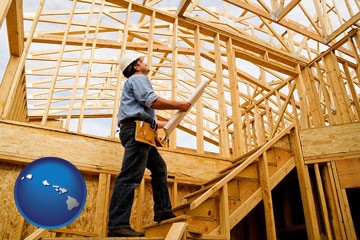 a custom home builder reviewing construction plans - with Hawaii icon